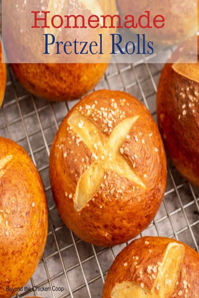 A closeup picture of pretzel rolls topped with salt.