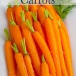 Small baby carrots on a white platter.