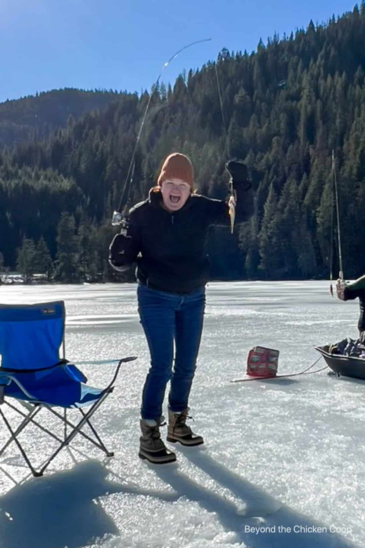 Catching a small fish while ice fishing. 