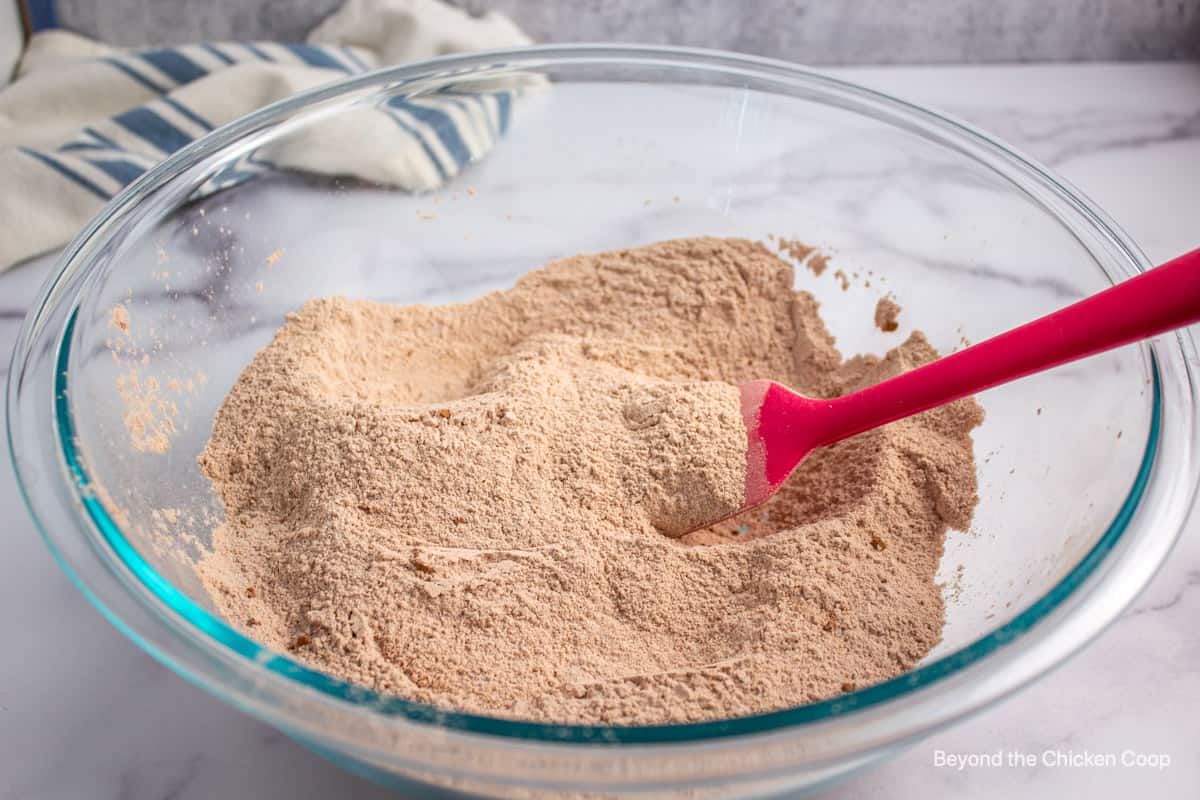 Flour, sugar and cocoa powder mixed together in a glass bowl.
