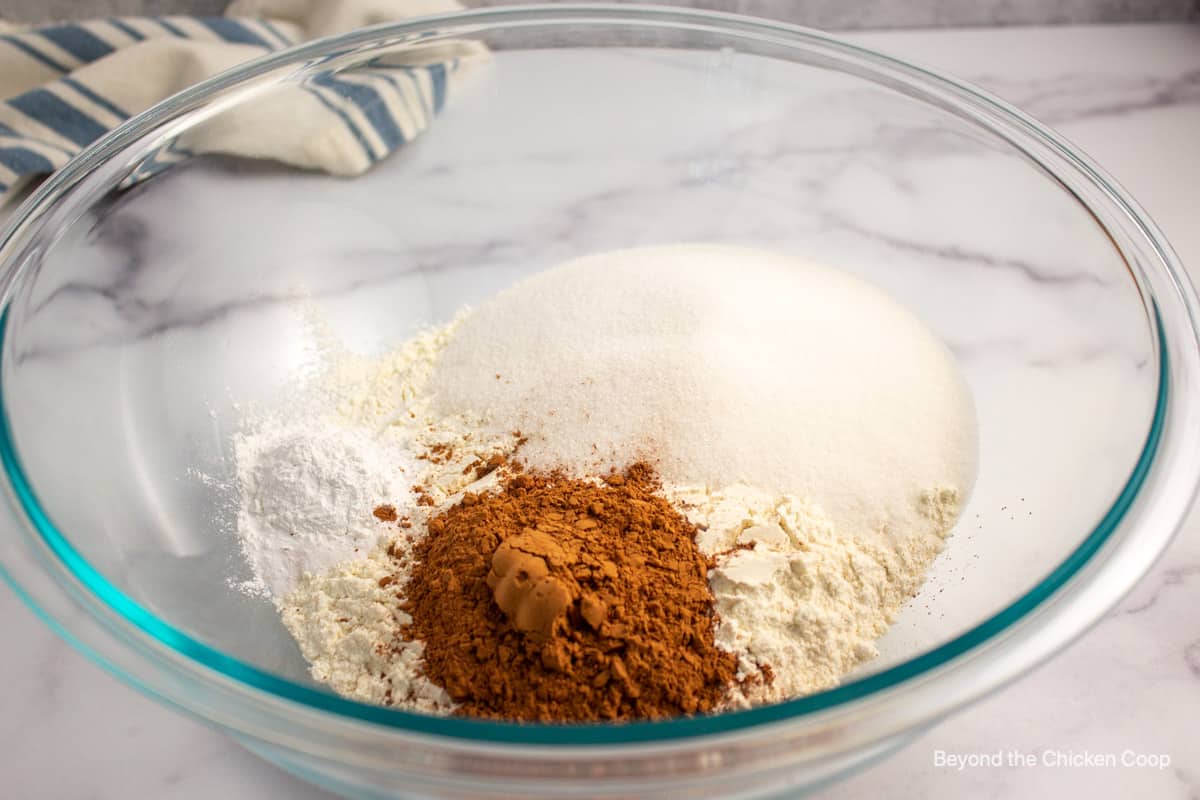 Dry cake ingredients in a glass bowl.