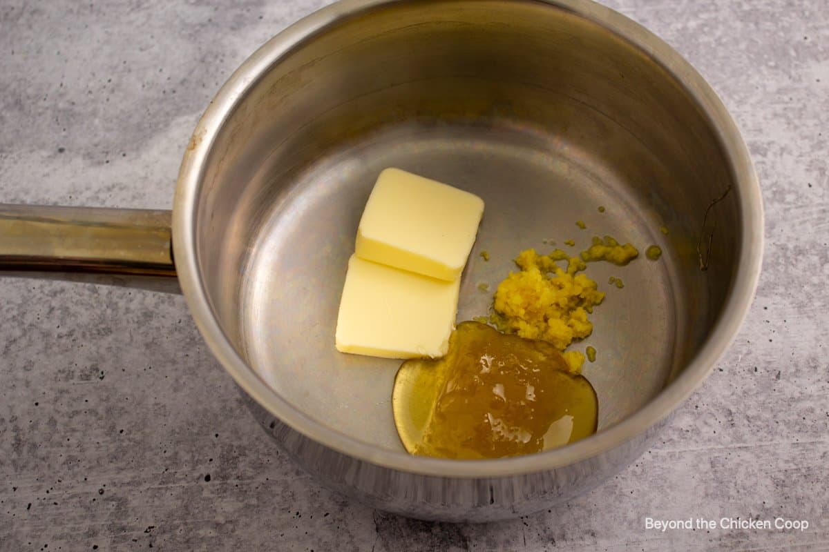 Butter, honey and ginger in a pot.