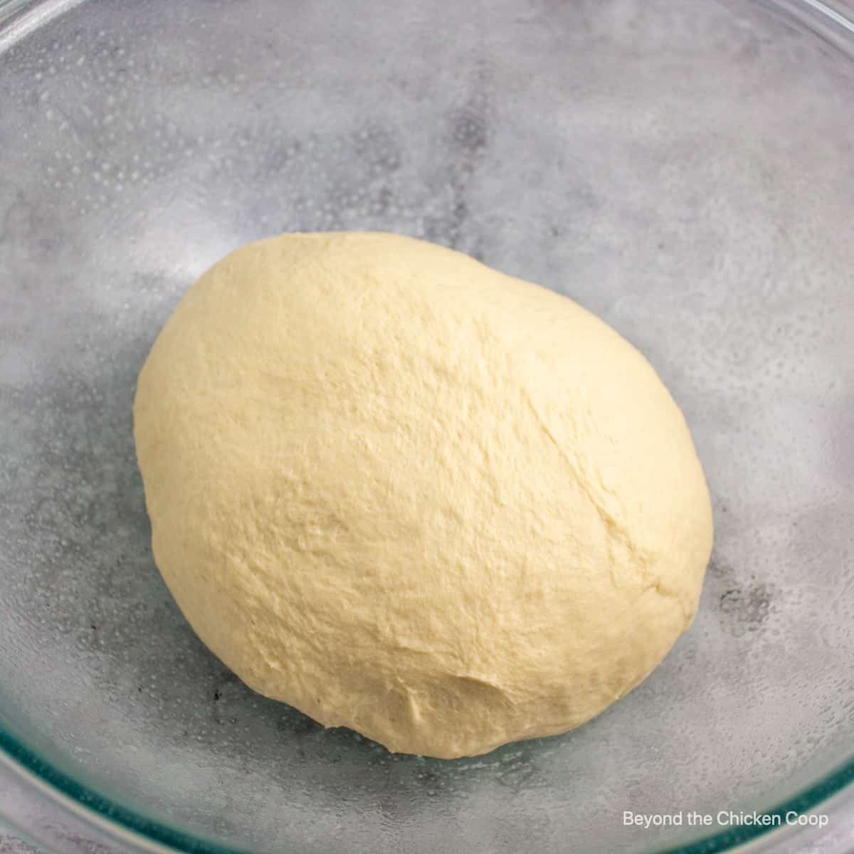 Dough in a glass bowl. 