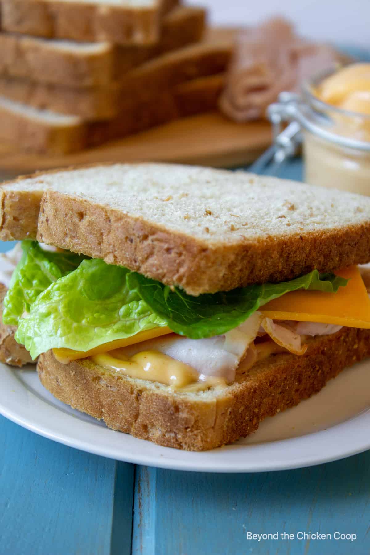 A turkey sandwich with lettuce and cheese.