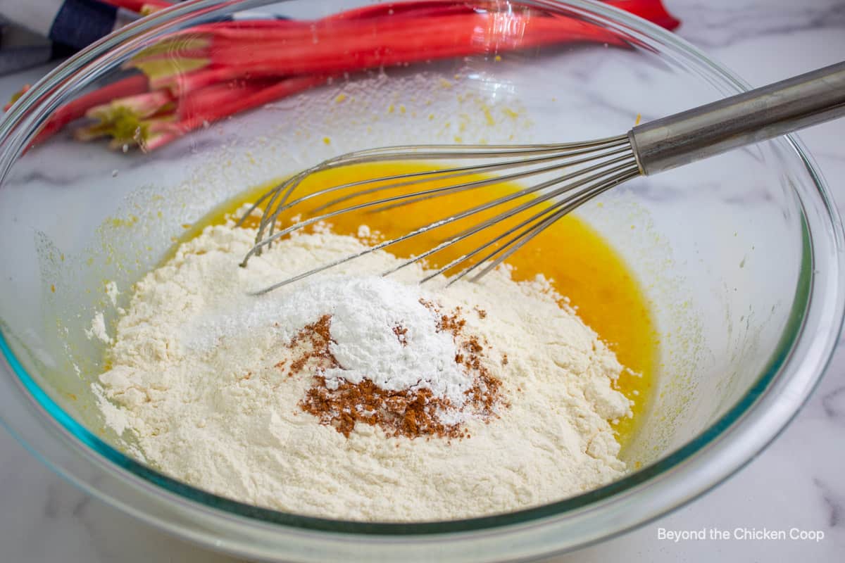 Flour and cinnamon added to a batter. 