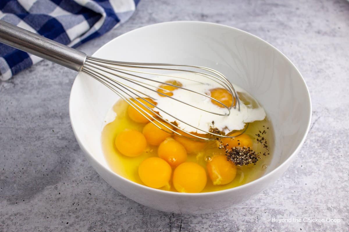 Eggs in a bowl with a whisk. 
