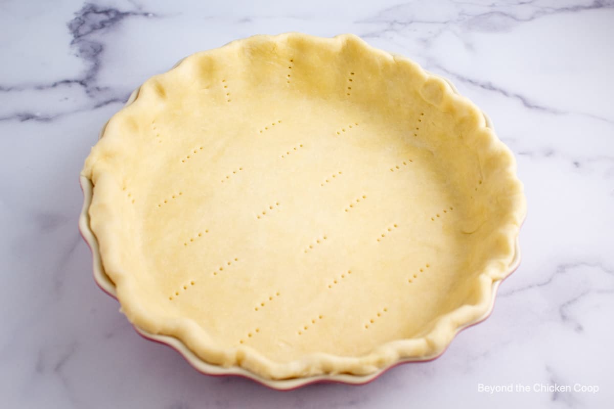 An unbaked pie crust in a pie plate. 