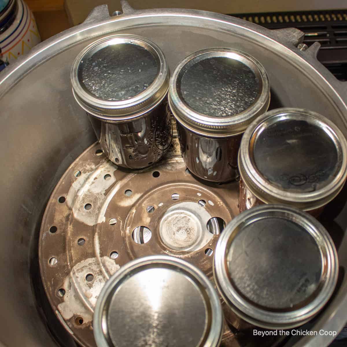 Placing jars in a pressure cooker.