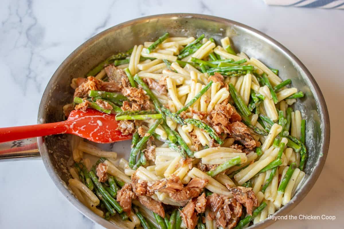 Asparagus, salmon and pasta in a pan.