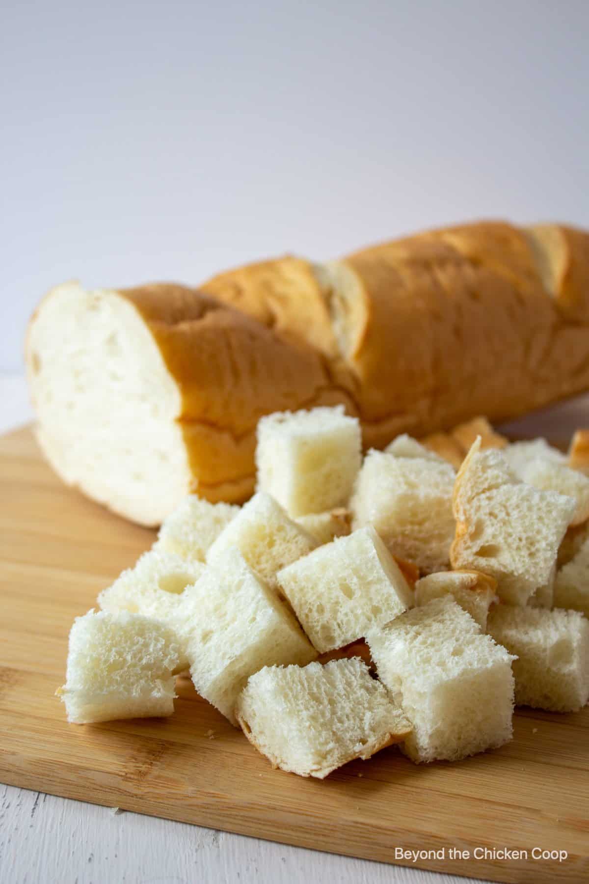 Cut bread on a cutting board.