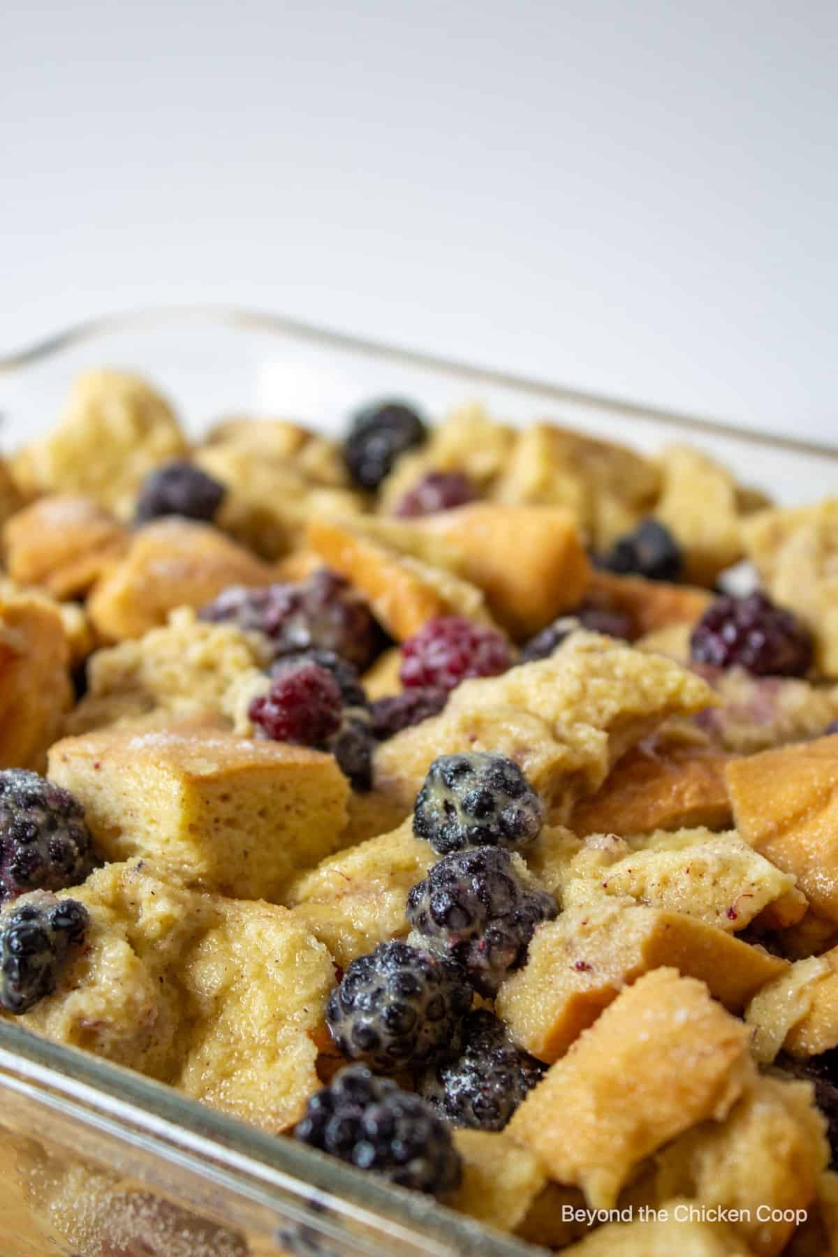 An unbaked breakfast casserole in a baking dish.