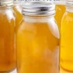 Canning jars filled with chicken stock.