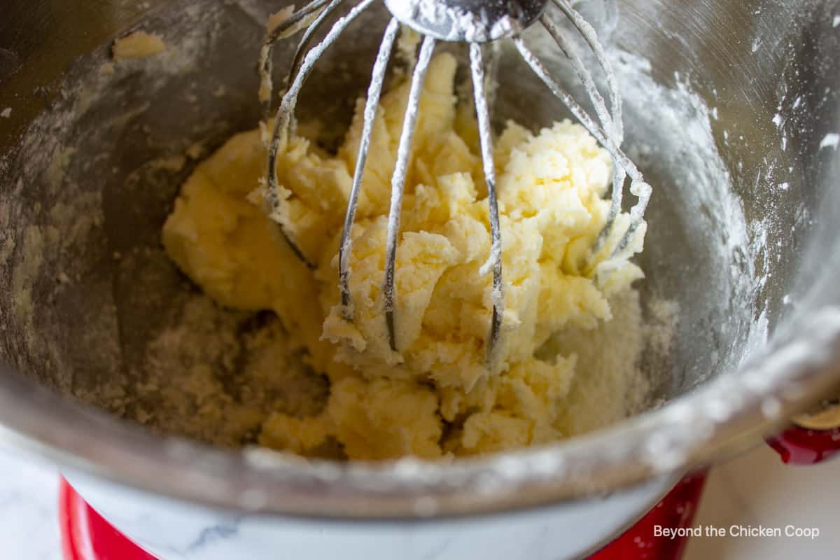 Thick butter mixture in a mixing bowl.