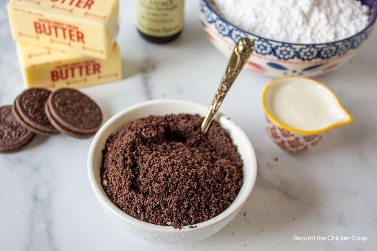 Finely ground cookie crumbs along with other ingredients for making oreo frosting. 