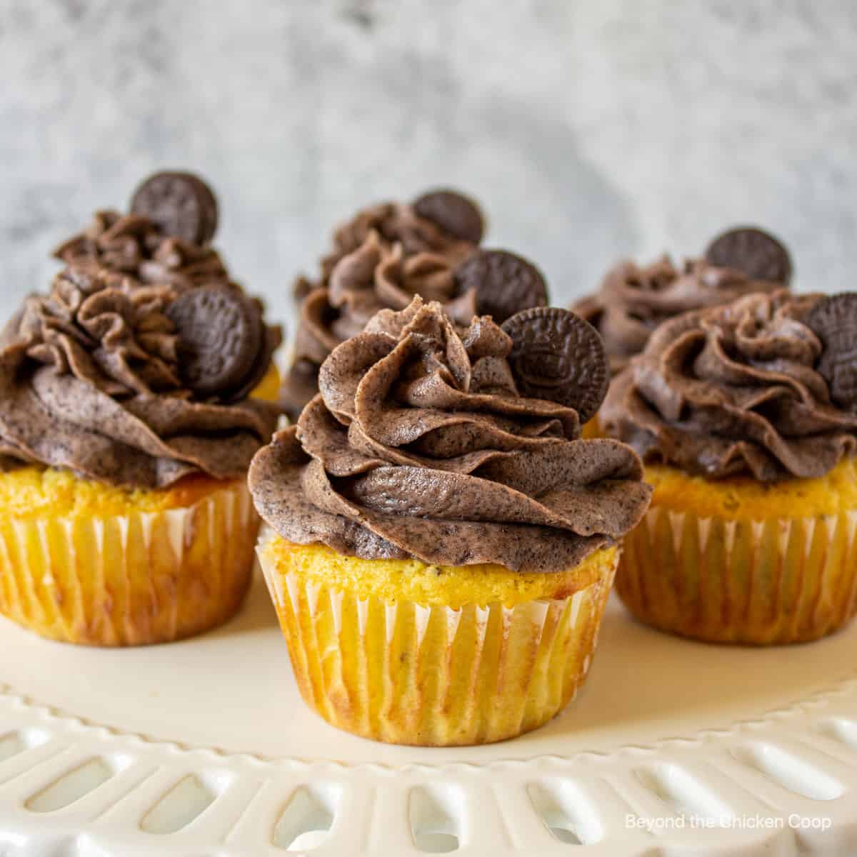 Oreo Cupcakes topped with a chocolate frosting.