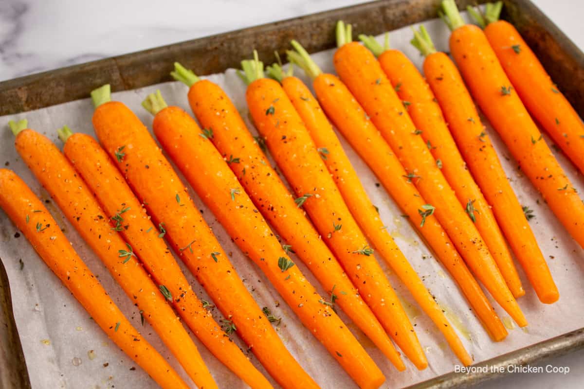 Whole baby carrots topped with fresh thyme.