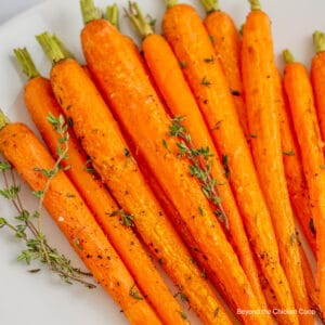 Baby carrots topped with fresh herbs.