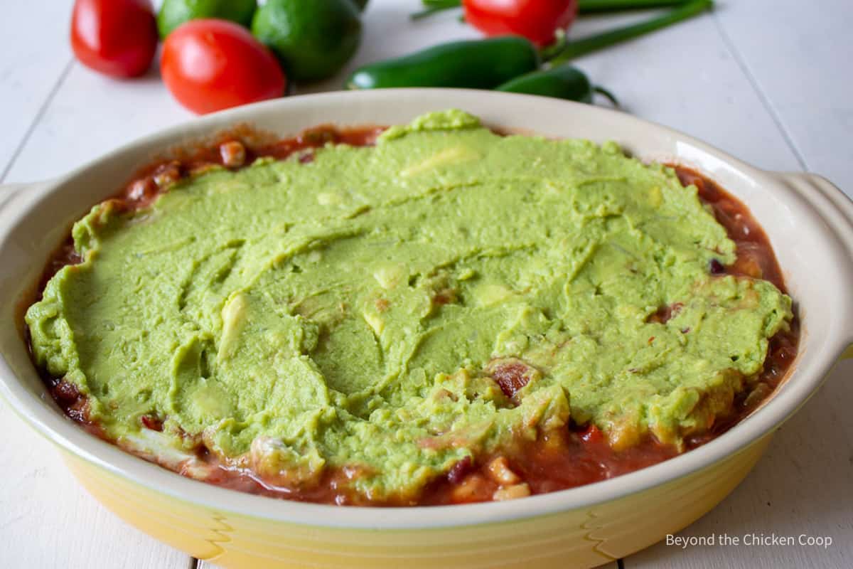 Adding guacamole to a 7 layer dip.