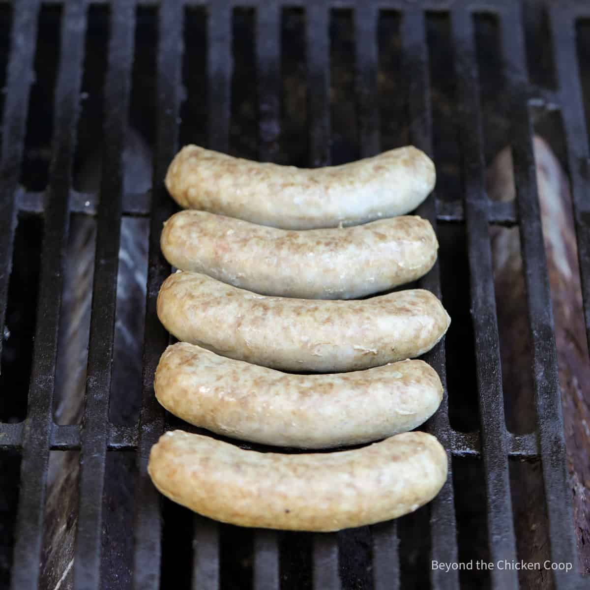 Cooked beer brats on a gas grill.