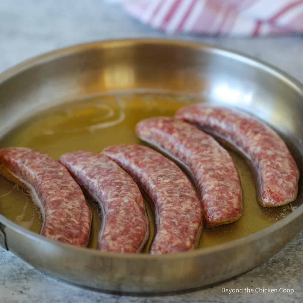 Sausages in a pan with beer.