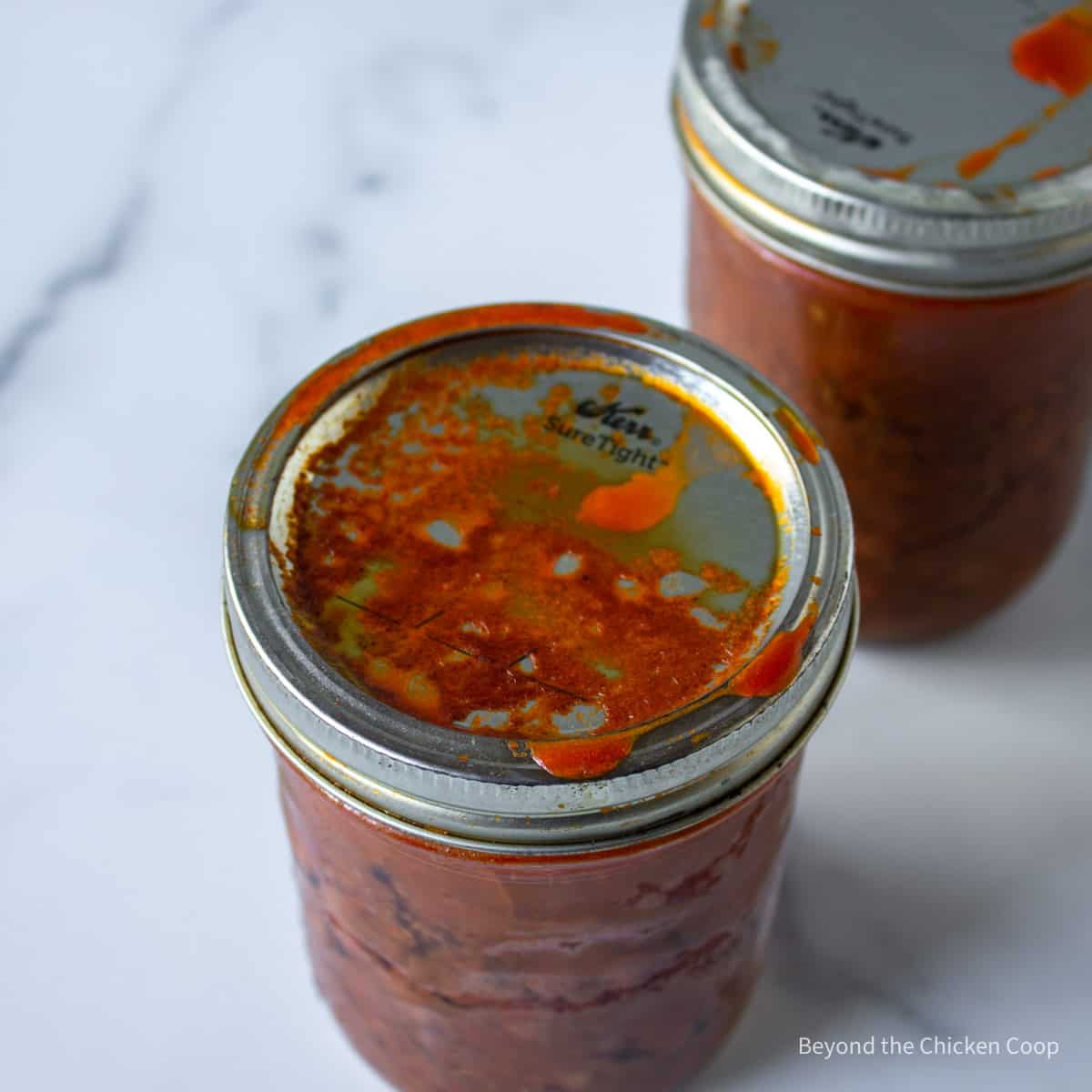 A messy canning jar filled with chili.
