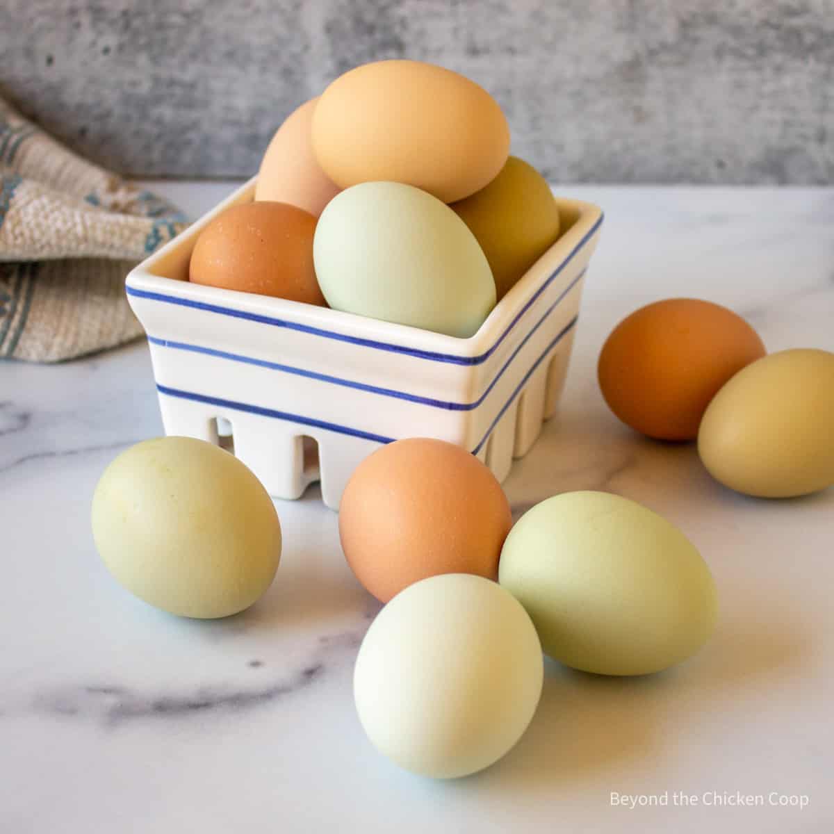 Different colored eggs in a basket.