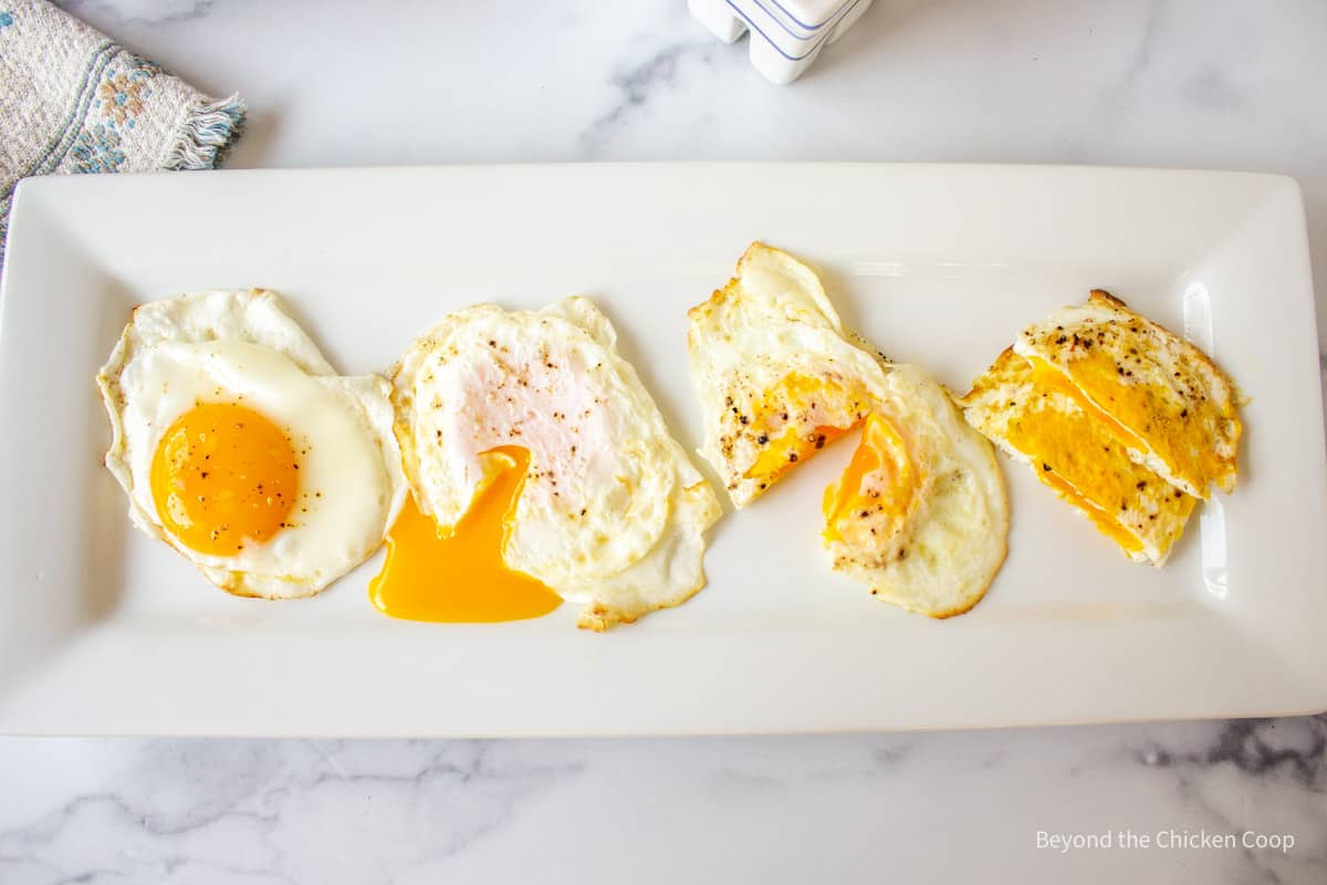 Different type of fried eggs on a plate.