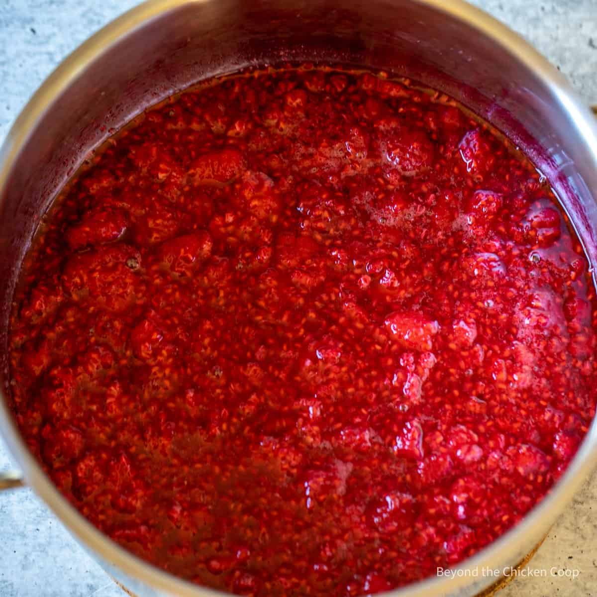 Cooked raspberries in a pot.