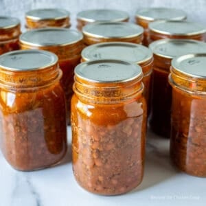 Canning jars filled with chili with beans.
