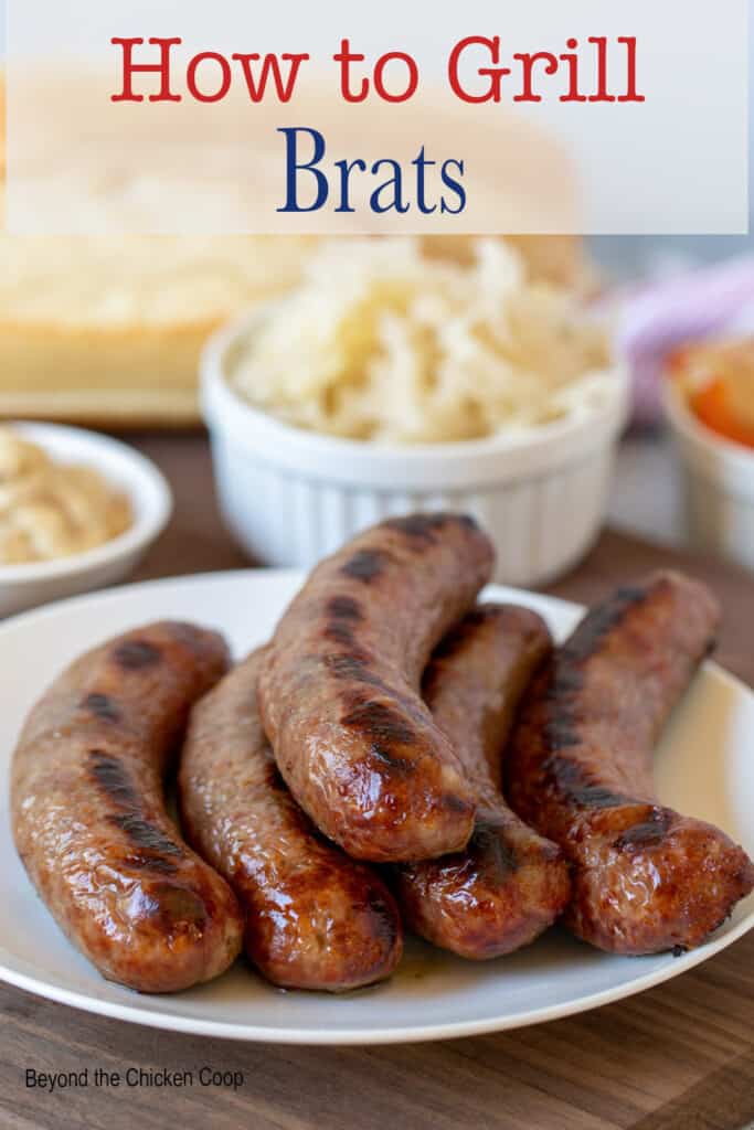 Five grilled sausages on a plate.