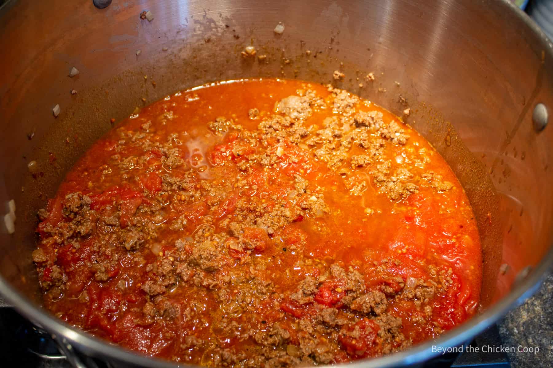 Tomato sauce with cooked burger.