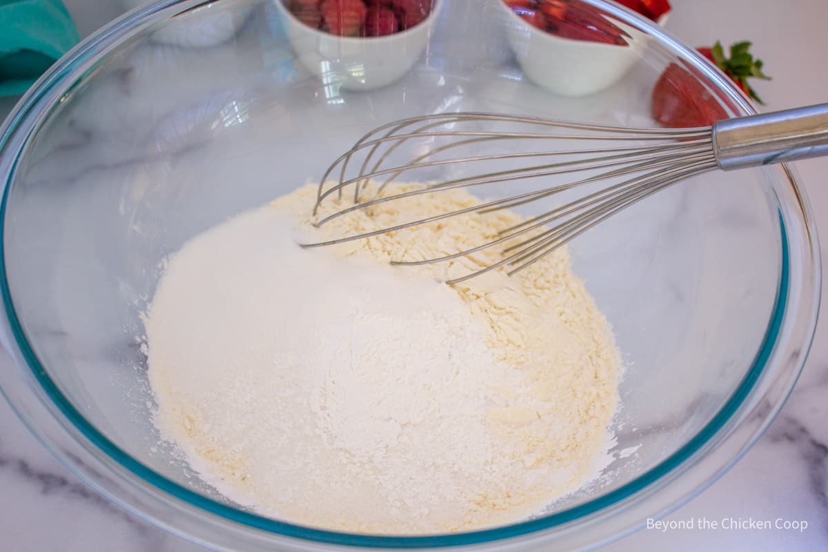 Mixing flour with a whisk.