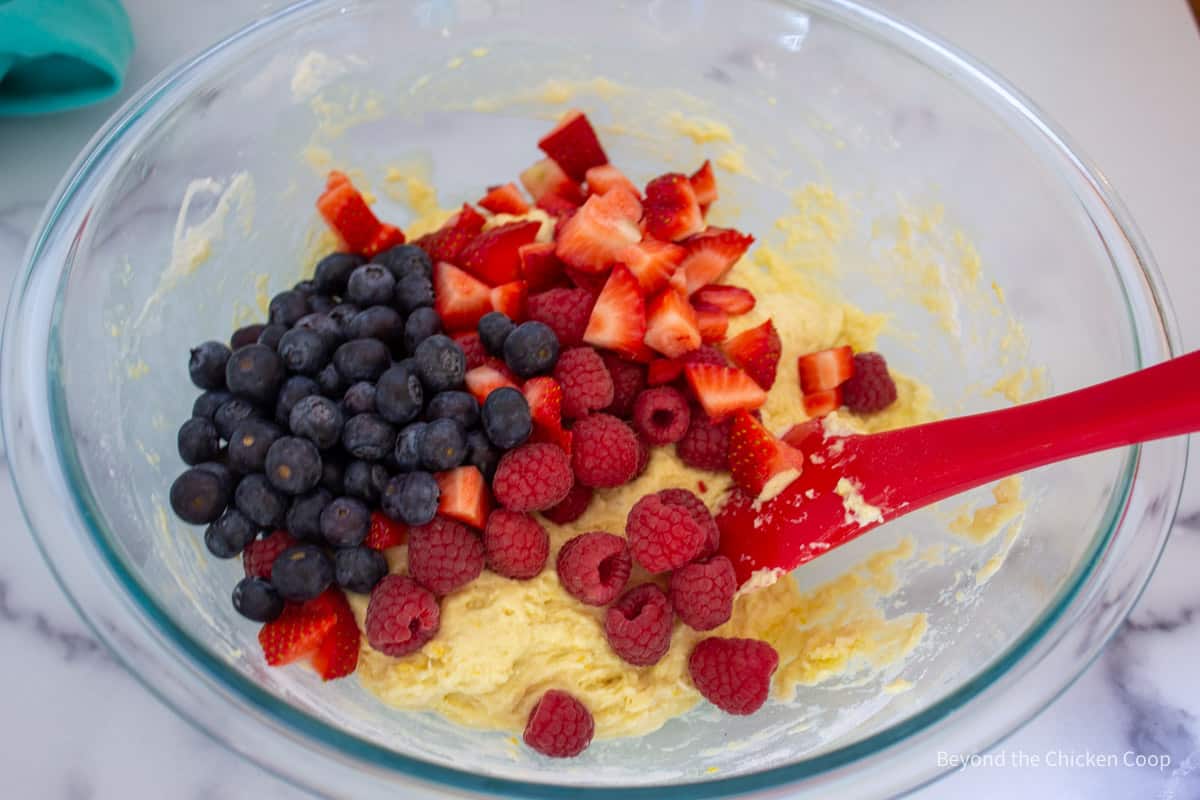Adding fruit to muffin batter.