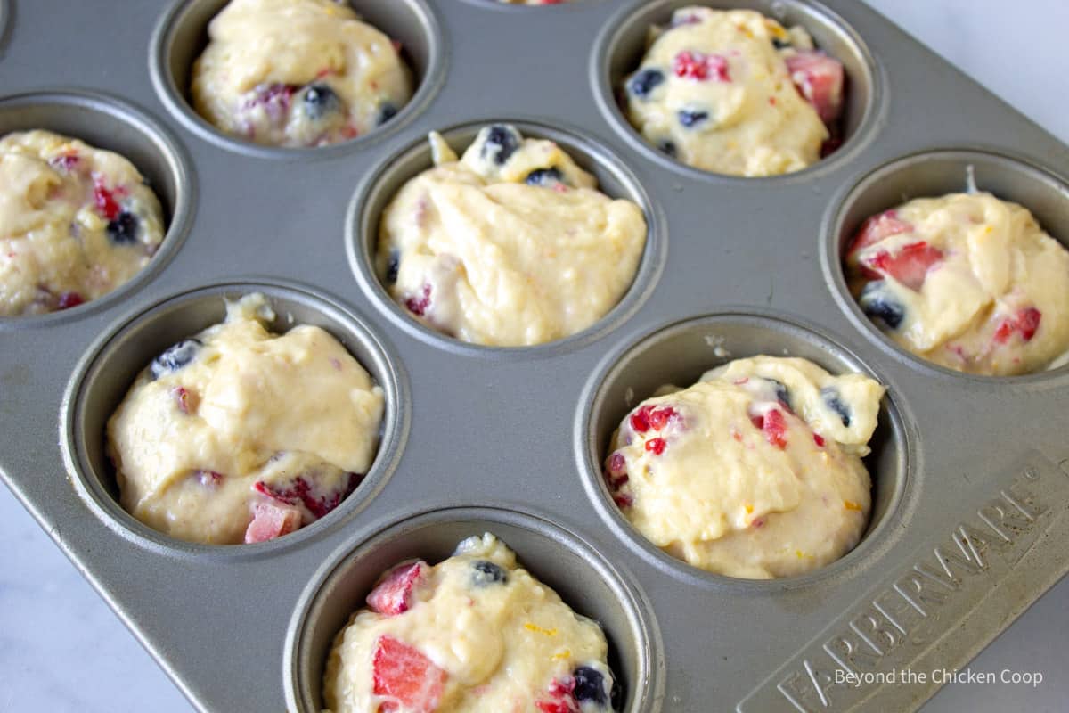 Muffin batter in muffin tin.