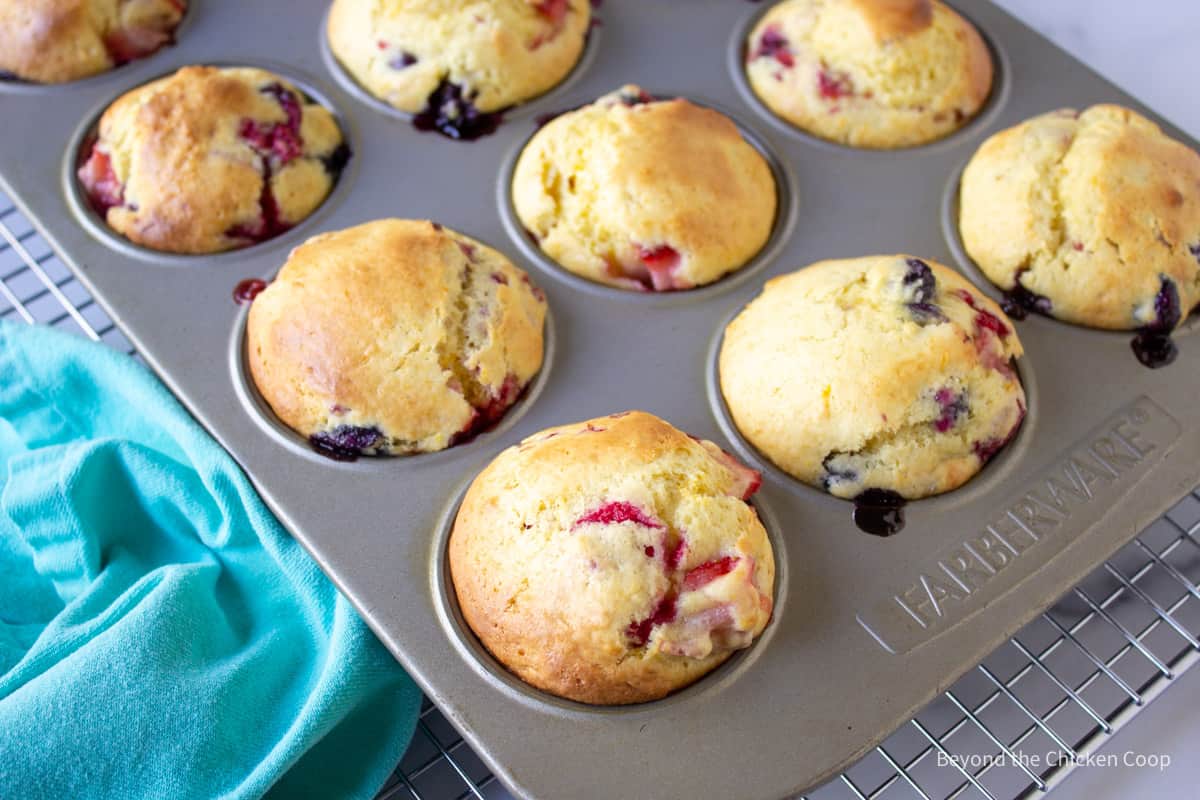 Baked berry muffins in a muffin tin.