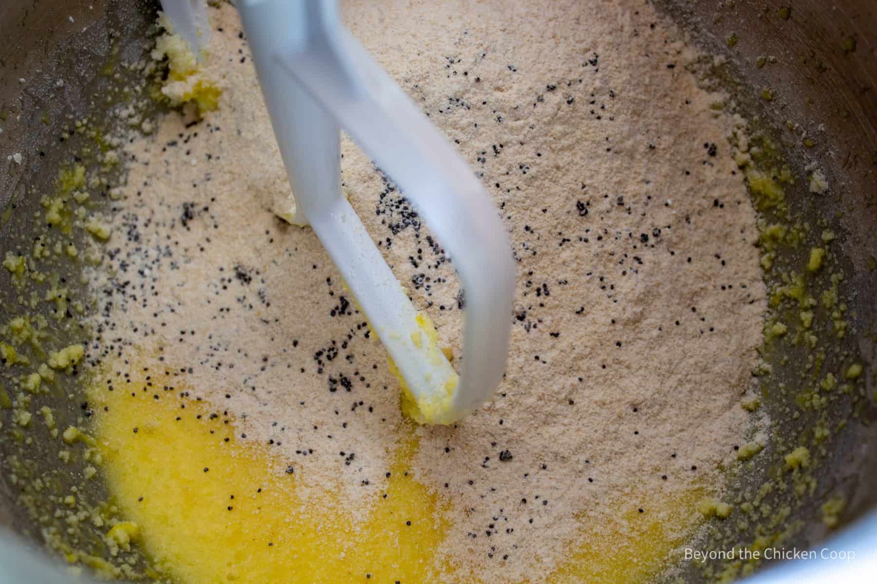 Flour with poppy seeds in a mixing bowl.