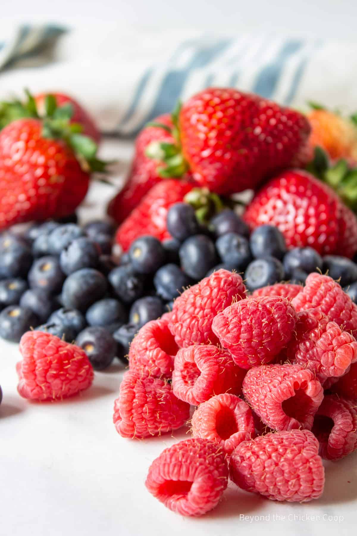 Raspberries, blueberries and strawberries piled together.