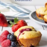 A berry muffin next to fresh berries.