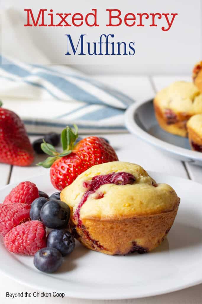 A berry muffin next to fresh berries.