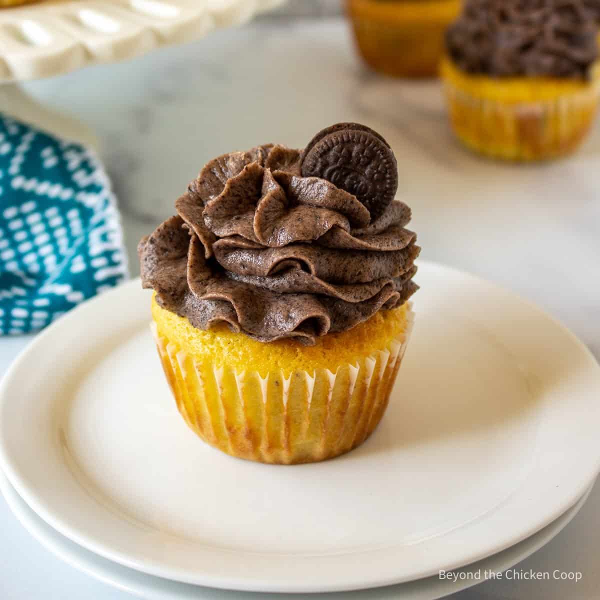 Frosting swirl on top of a yellow cupcake.