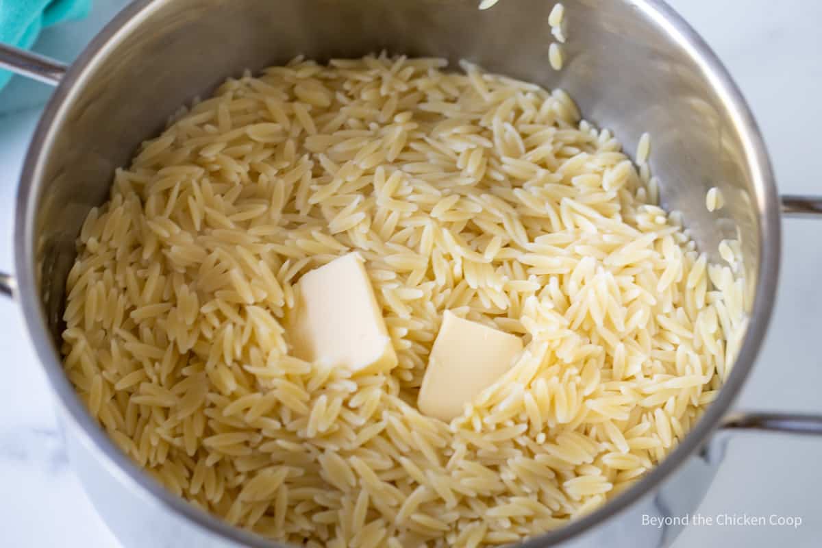 Orzo with butter in a pot.