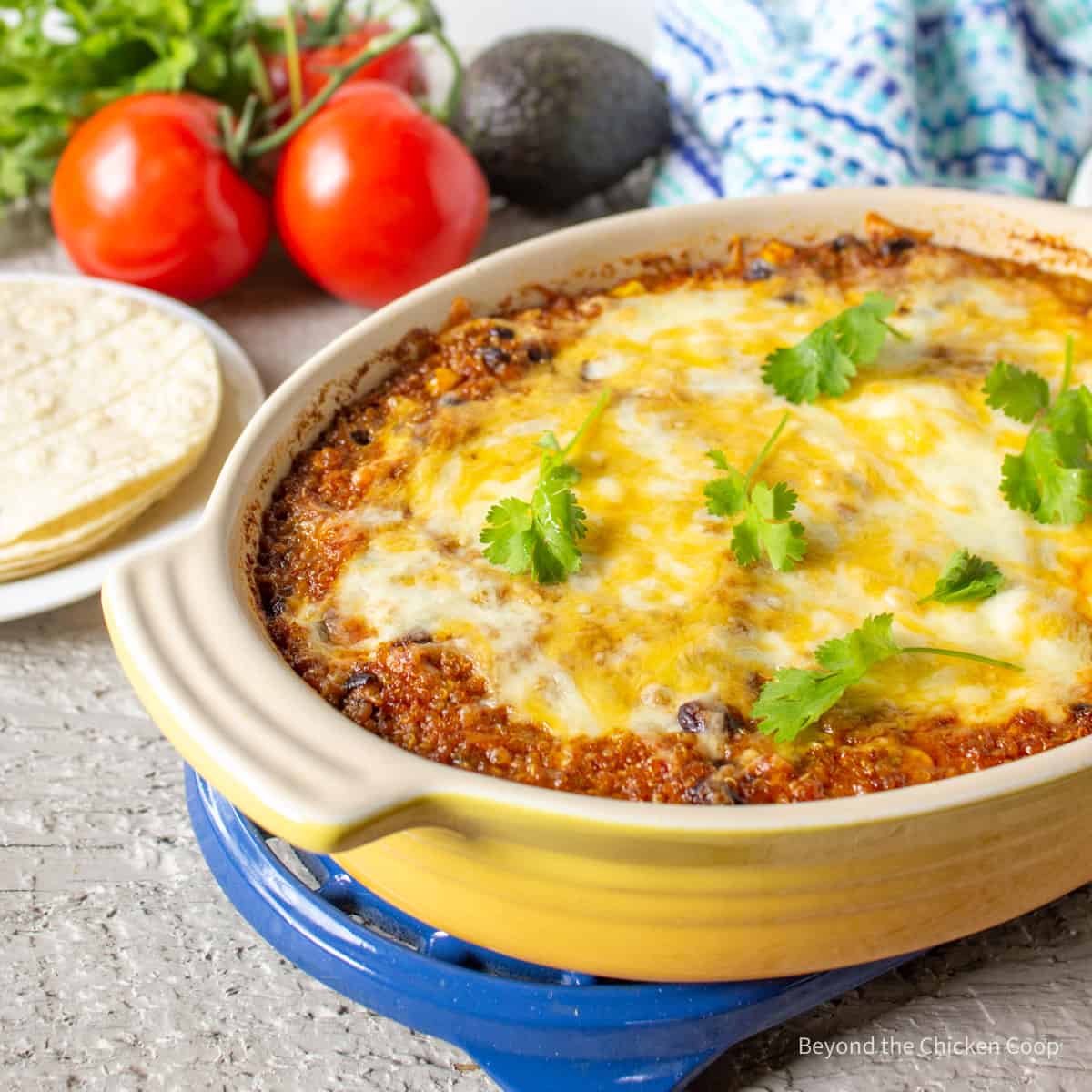 Quinoa enchilada bake topped with melted cheese and cilantro.