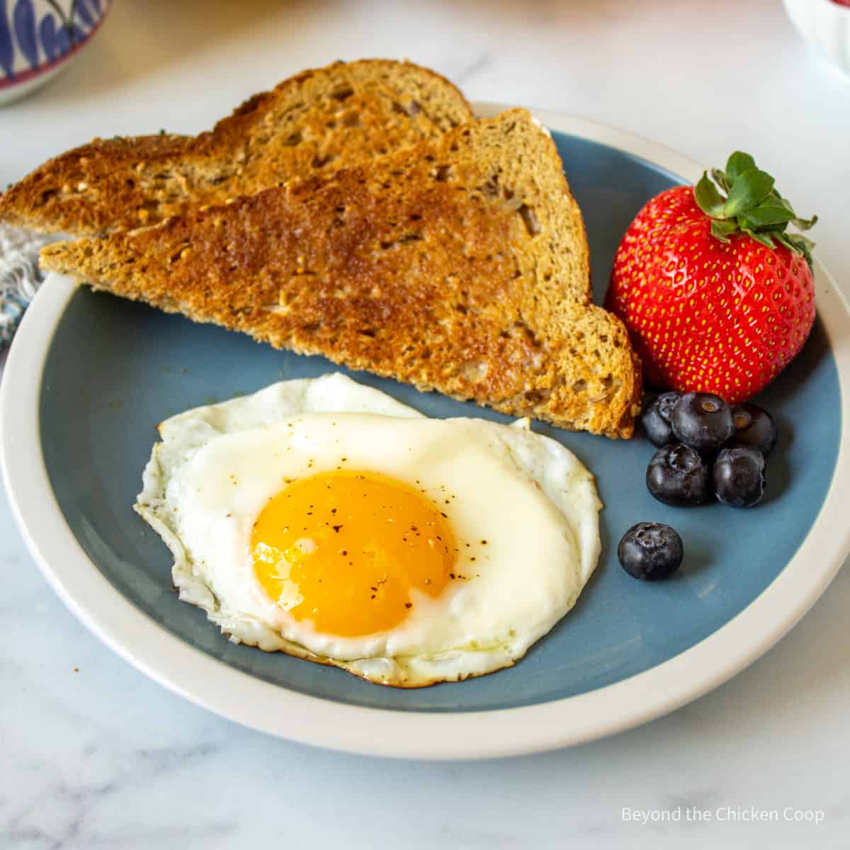 A sunny side up egg on a plate.