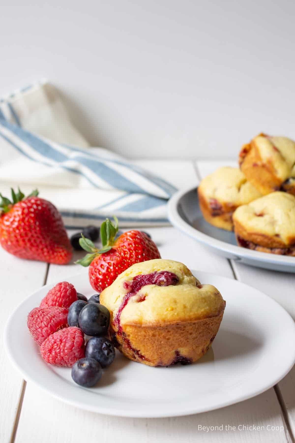A berry muffin with fresh berries.