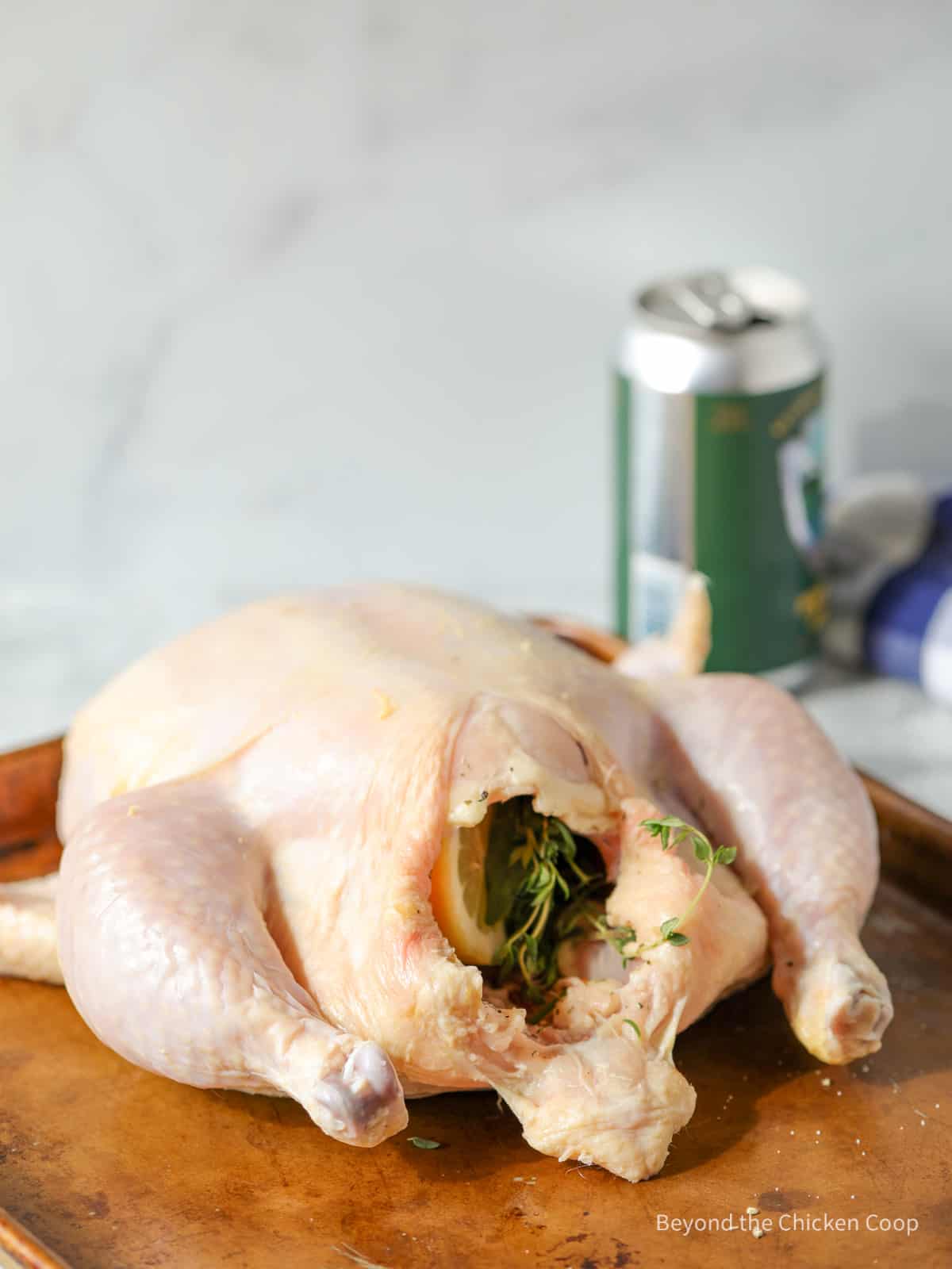 A chicken stuffed with herbs and a lemon.