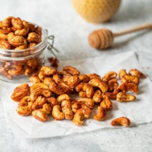 A pile of cashews on parchment paper.