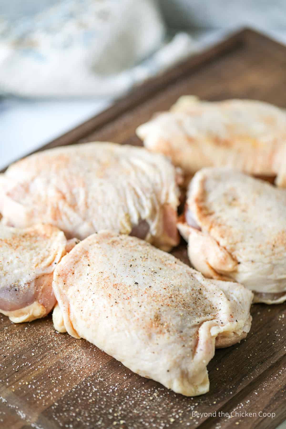 Chicken thighs with seasoning.
