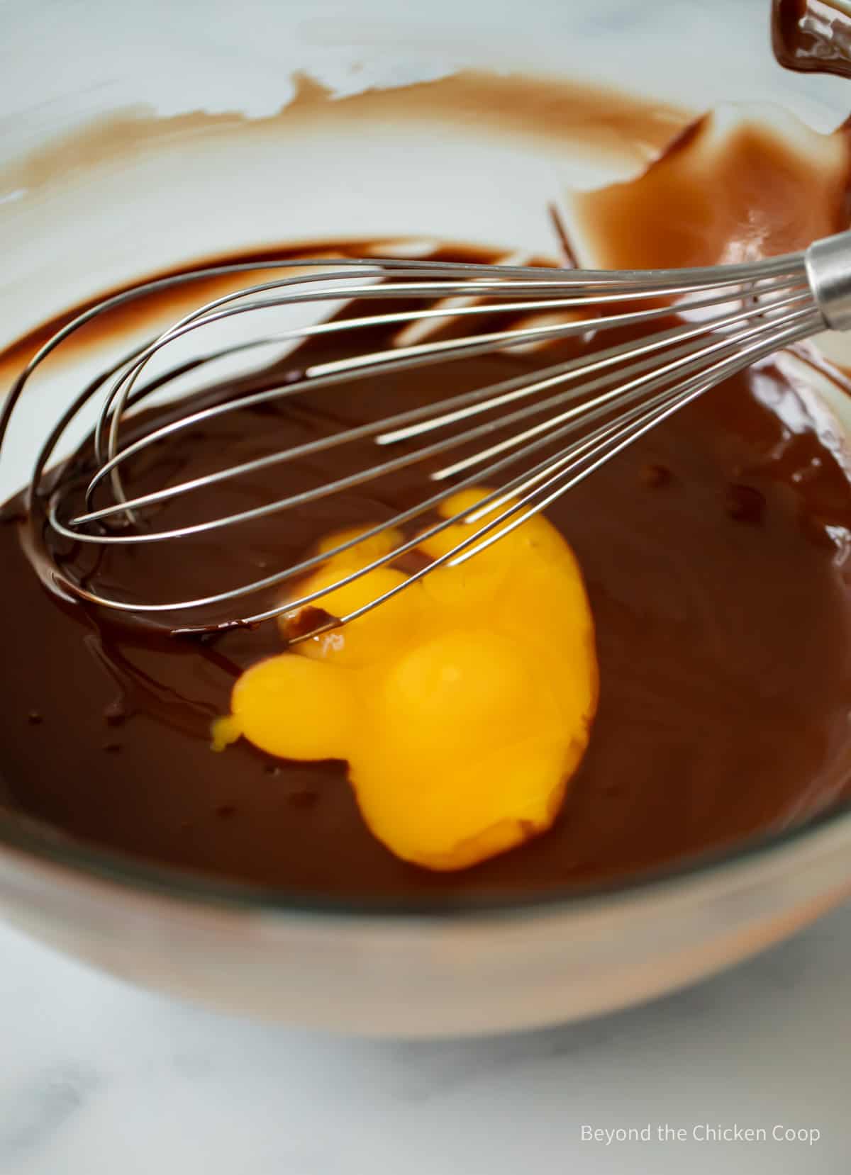 Mixing egg yolks into chocolate mixture.