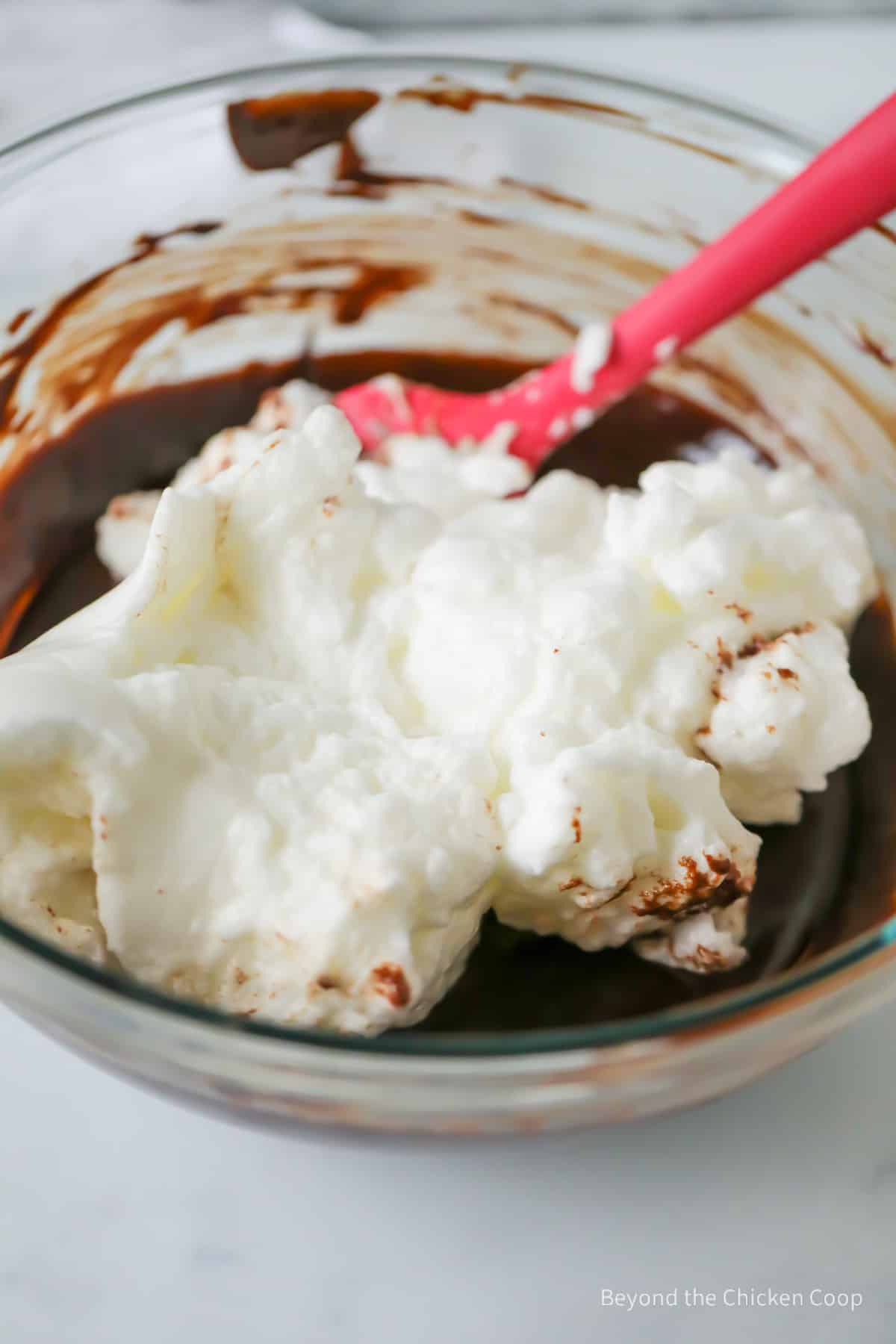 Folding egg whites into batter.