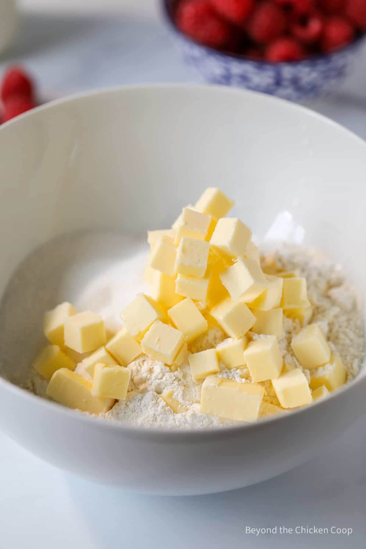 Cubes of butter in a bowl of flour.